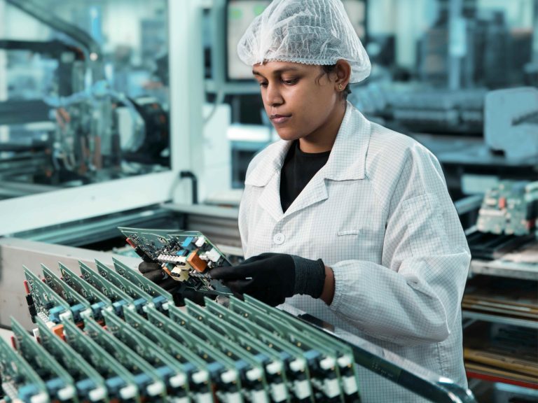Woman assembles PCB
